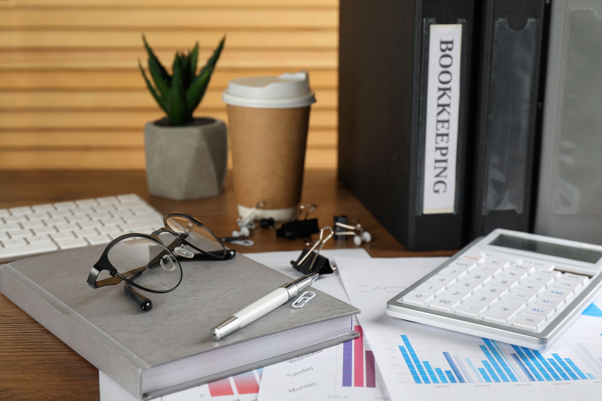 Bookkeeper's workplace with folders and documents on table